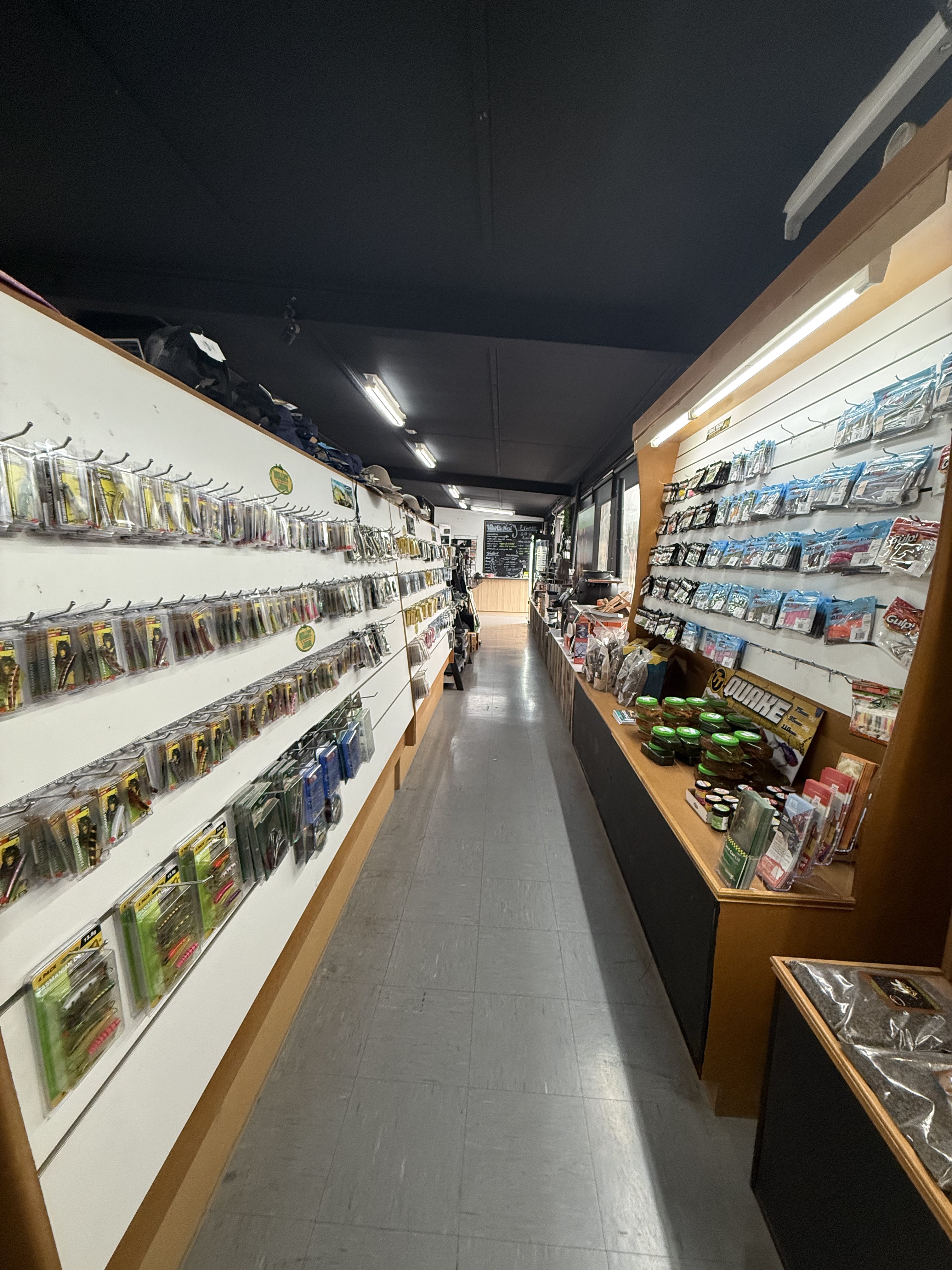 Summit Outfitters store aisle with lures, hooks, bait, reels & fishing accessories