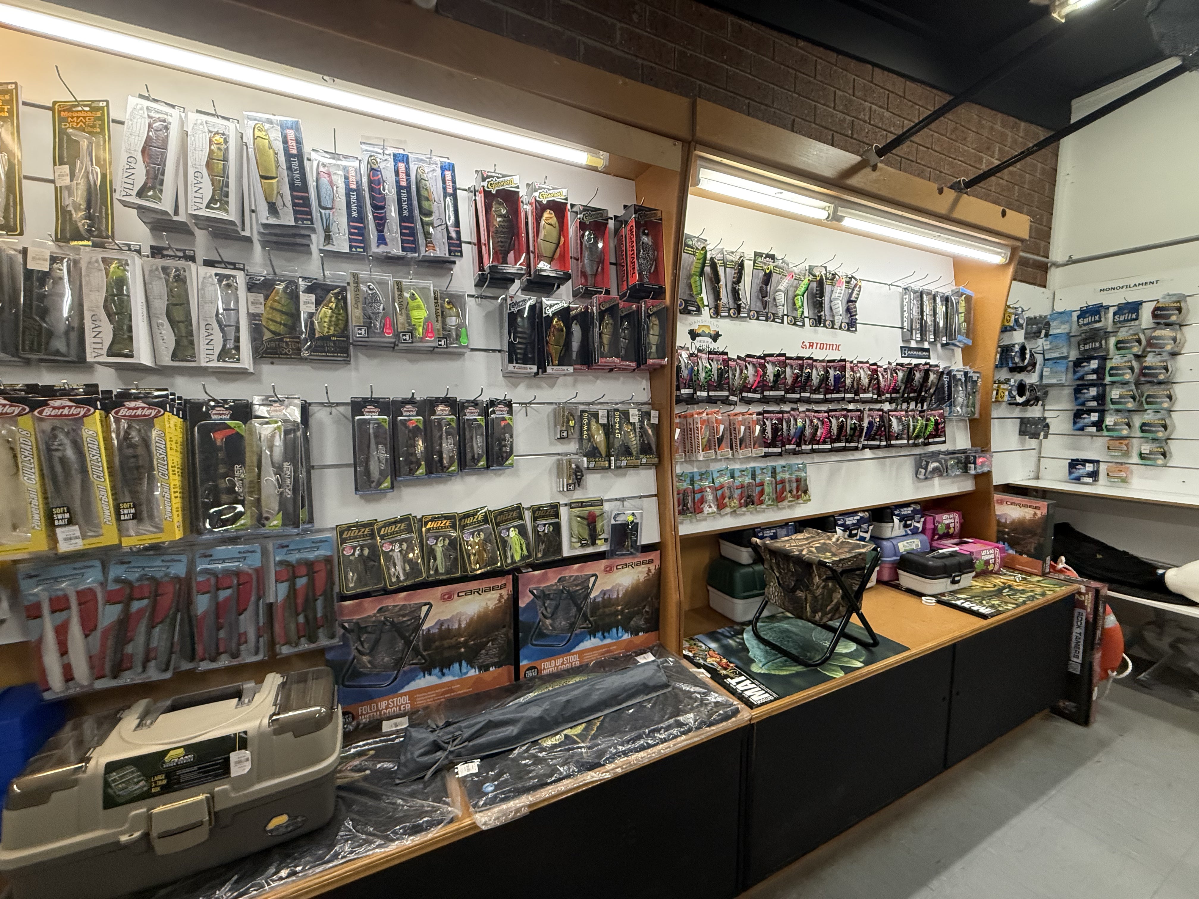Summit Outfitters store wall with Berkley, Atomic lures, tackle boxes & fishing gear