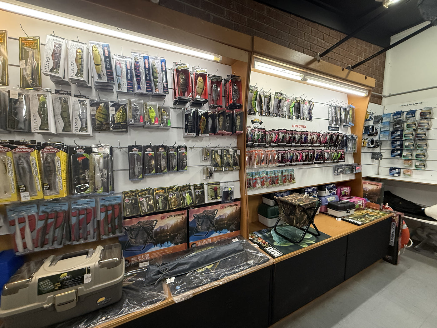 Summit Outfitters store wall with Berkley, Atomic lures, tackle boxes & fishing gear