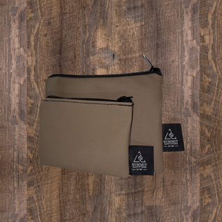 two brown pencil cases sitting on wooden surface
