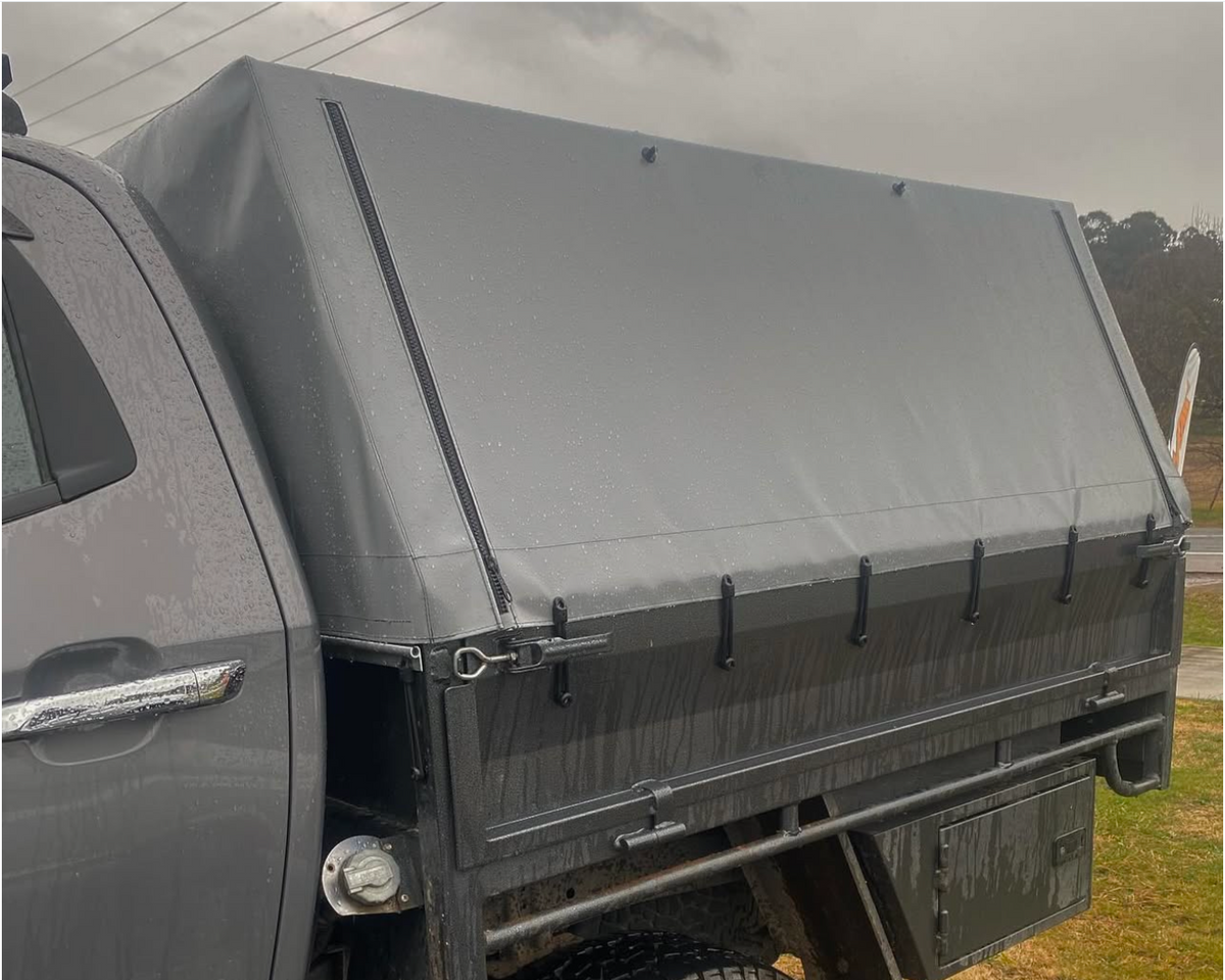 Canvas truck cover canopy on pickup bed with straps fastened