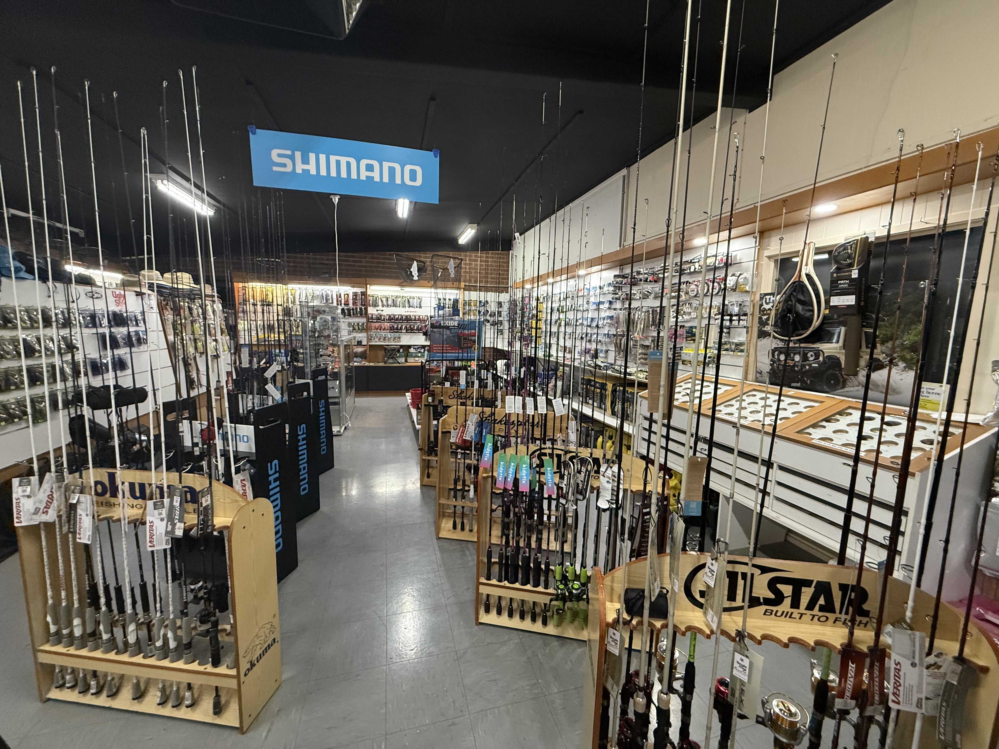 Inside Summit Outfitters store with fishing rods, reels, lures & more
