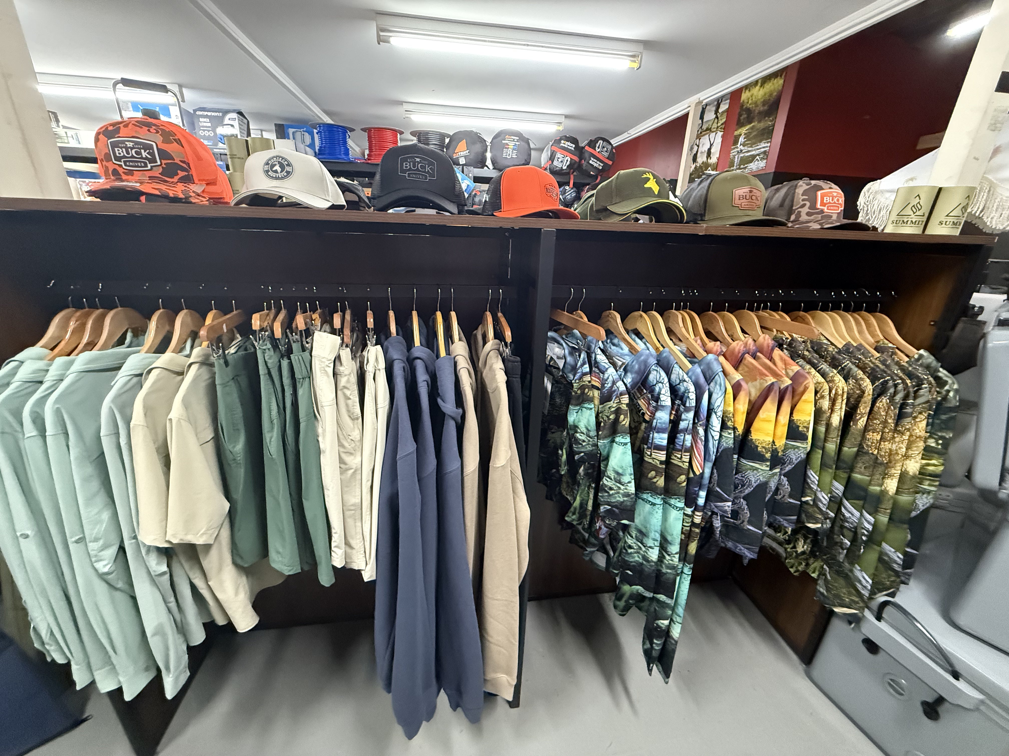 Summit Outfitters store rack with Fishing Shirts, Outdoor Clothing, Hats & Accessories on display