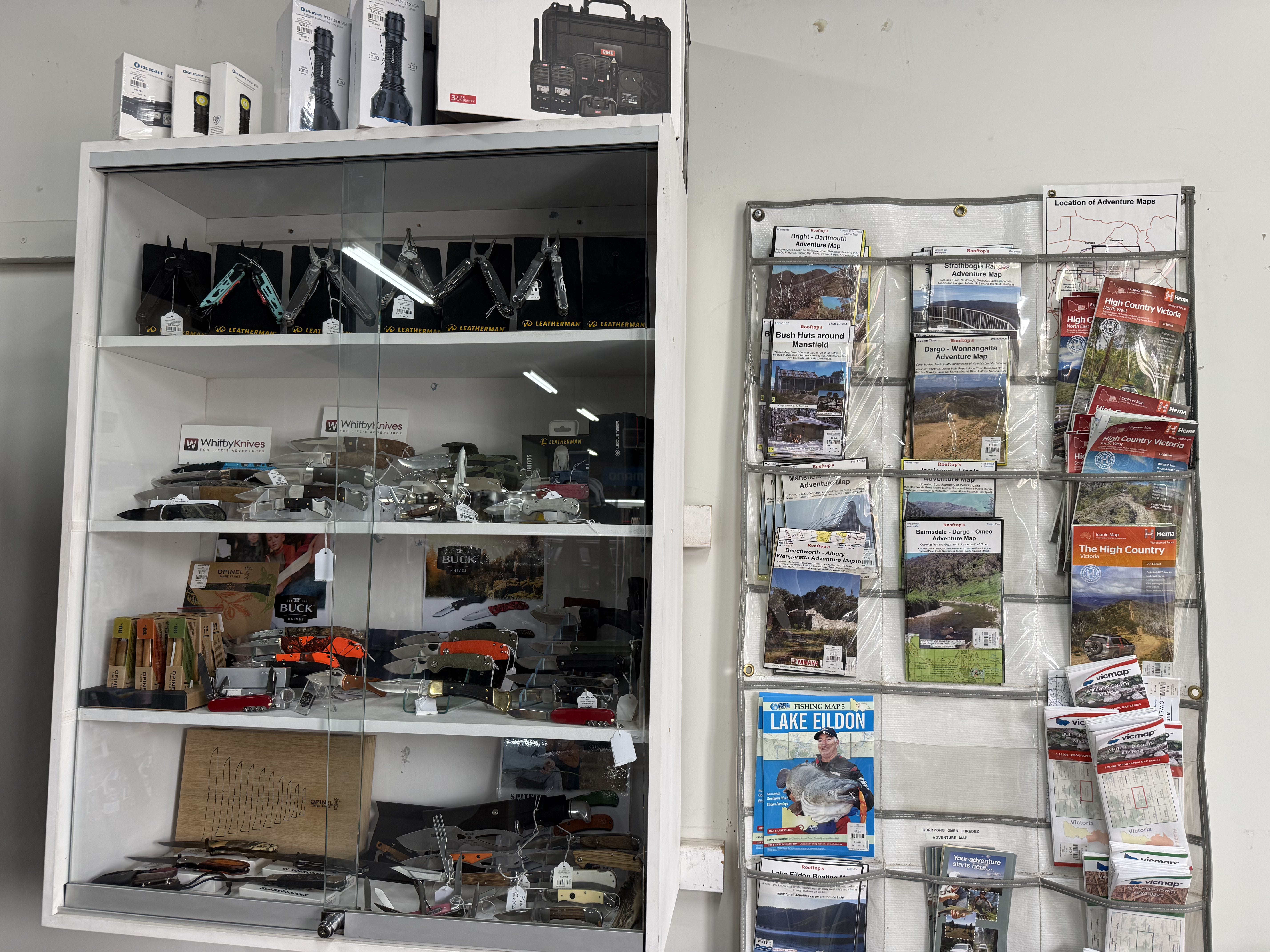Summit Outfitters store cabinet with Leatherman tools, knives, maps & adventure guides