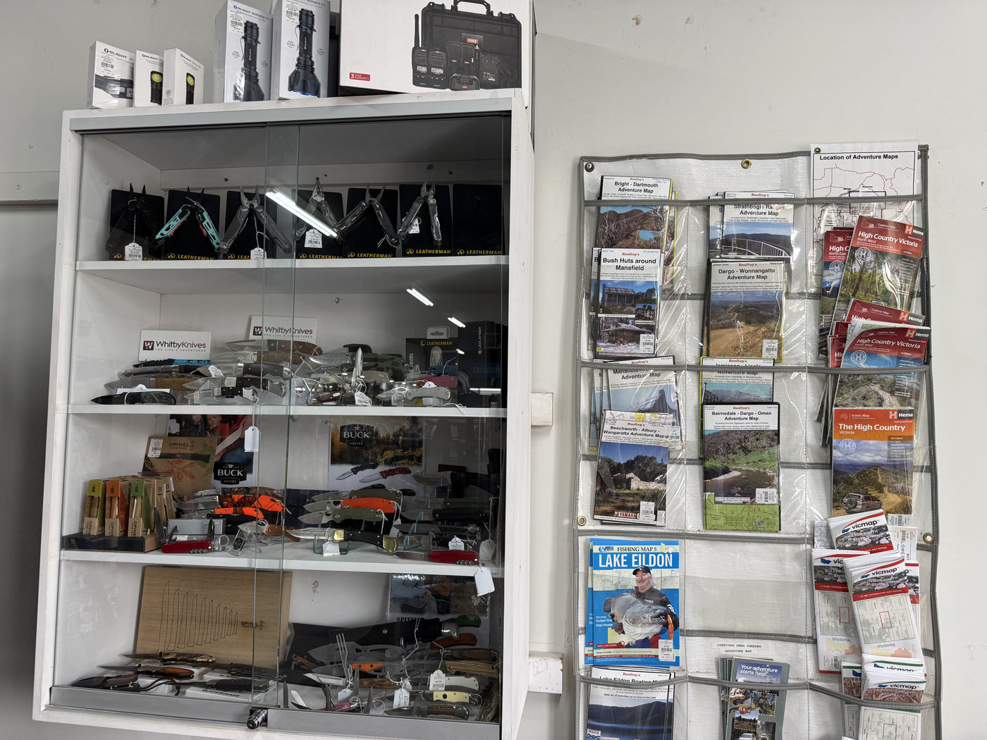 Summit Outfitters store cabinet with Leatherman tools, knives, maps & adventure guides