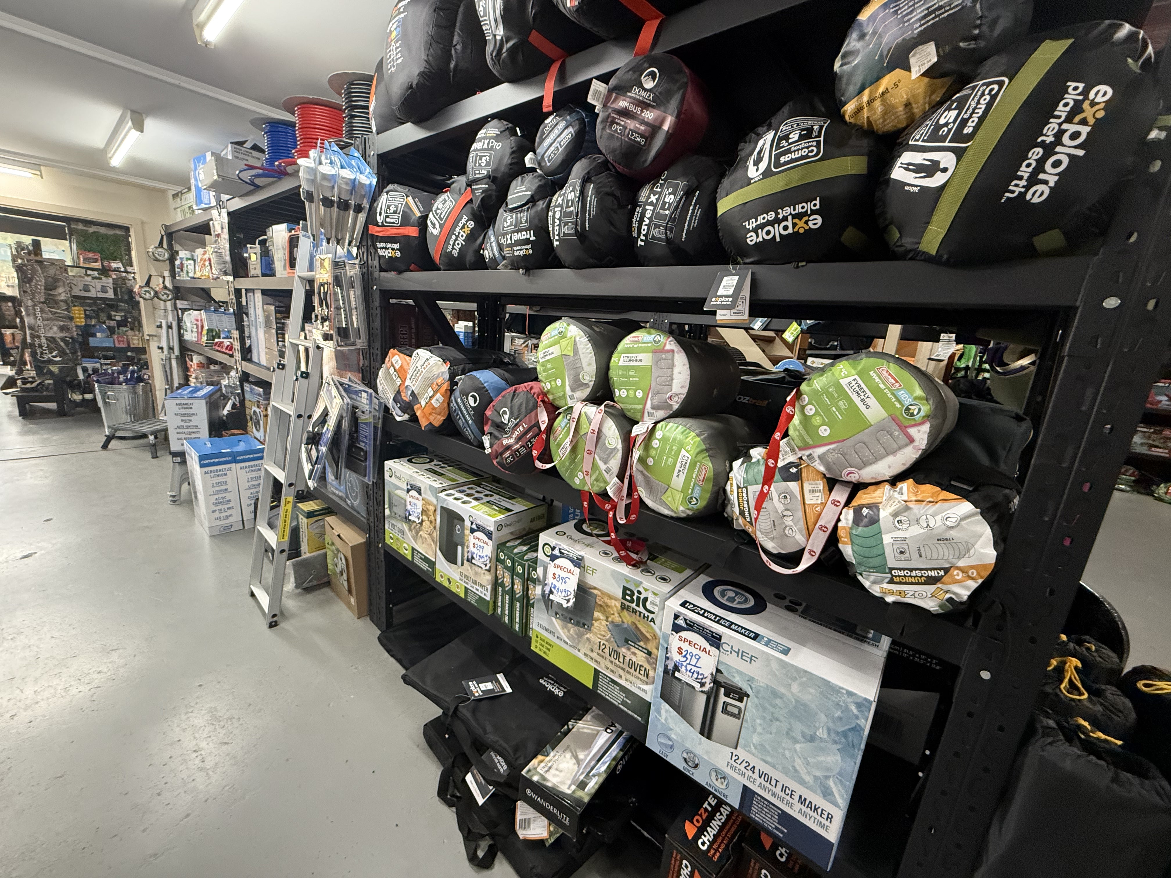 Summit Outfitters store shelves showing Sleeping Bags, Caravanning Toilet, Cooking & Heating supplies