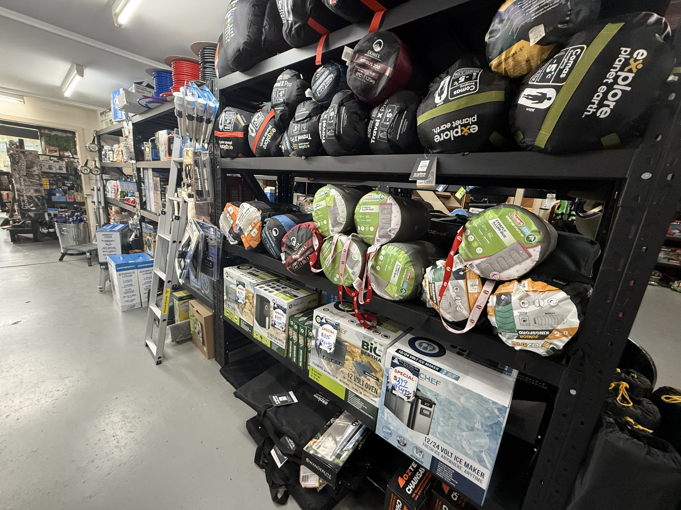 Summit Outfitters store shelves showing Sleeping Bags, Caravanning Toilet, Cooking & Heating supplies