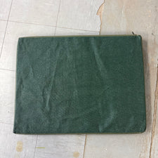 meshy under side shown of green canvas dog bed.