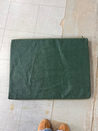 meshy under side shown of green canvas dog bed.