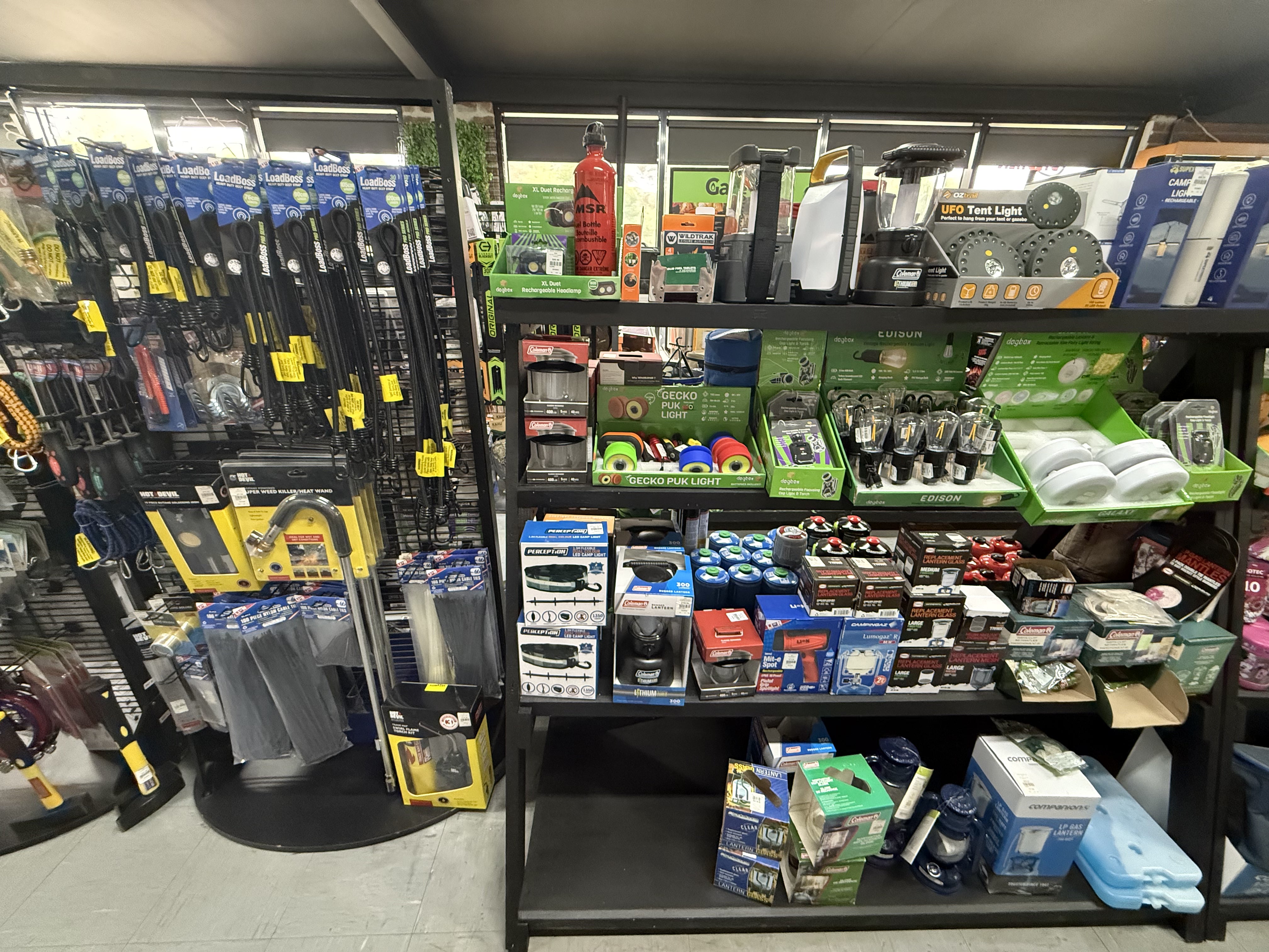 Summit Outfitters store shelves with Travel Essentials, Torches & Lights